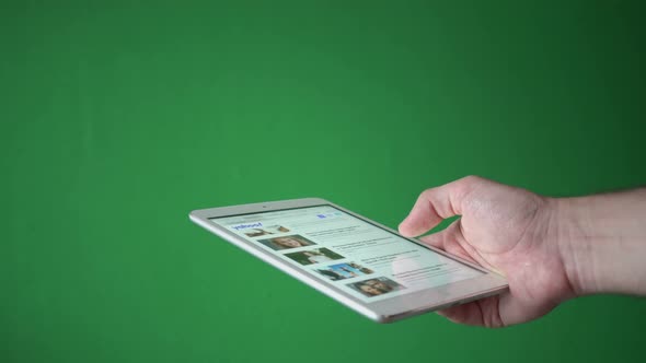 Man Reading News On Tablet Isolated On Chroma Key Green Screen Background