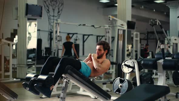 Handsome Bearded Young Man Doing Abs Exercises During Sport Workout Training.