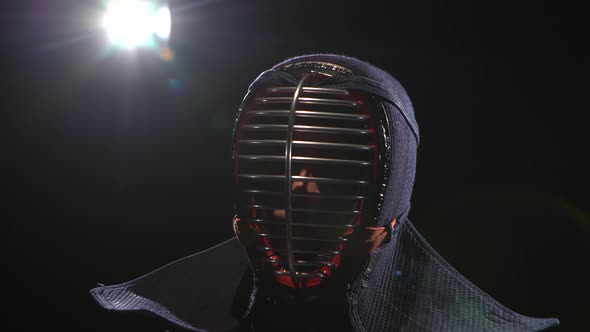 Kendo Guru Sitting on the Floor in an Traditional Helmet. Close-up