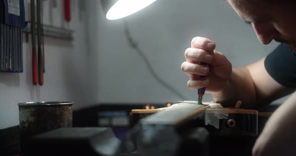 Refretting the Guitar Luthier Replaces Frets on the Electric Guitar Musical Instruments Repair Shop