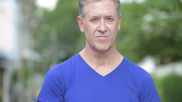 Face of Happy Mature Man Smiling in the Streets Outdoors