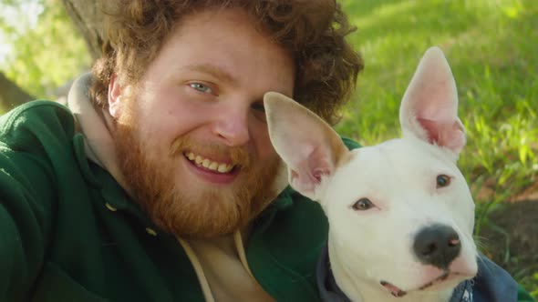 POV of Smiling Man Taking Selfie with Dog