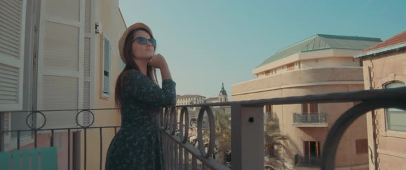 Woman standing on the balcony in Europe