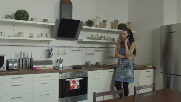 Drunk Man Finding Wife Talking on Phone in Kitchen