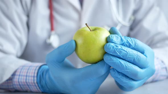 Doctor's Hand Holding Green Apple While Sited