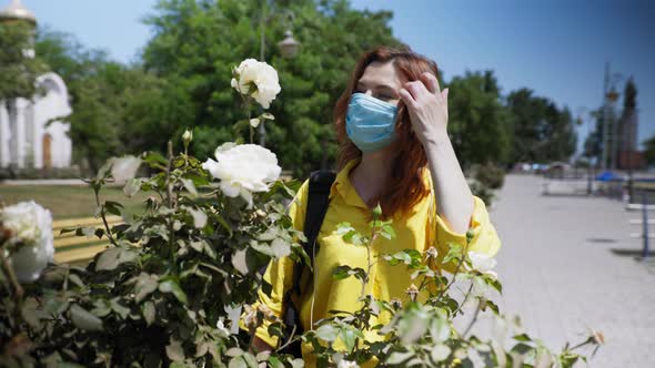 Young Beautiful Girl Observes Safety Measures During Pandemic and Wears Medical Protective Mask and