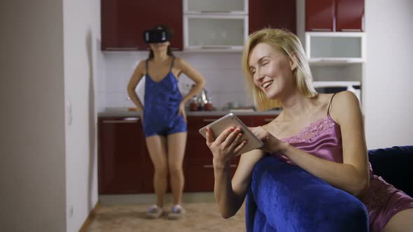 Young Woman Using Virtual Reality Glasses at Home