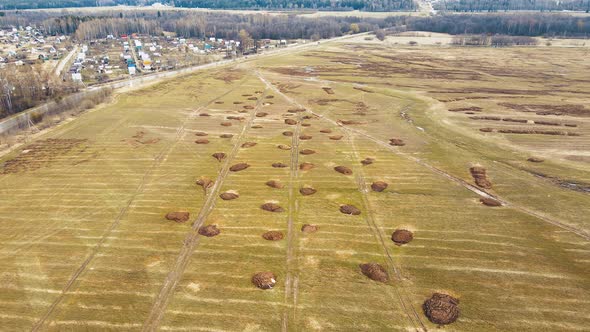 Small Round Heaps of Manure on an Agricultural Field Aerial View