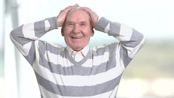 Cheerful Elderly Man Raised Hands in Happiness.