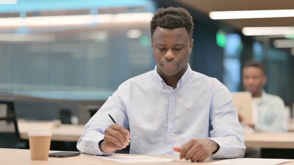 African Businessman Trying to Write on Paper Failure