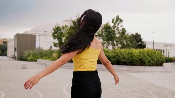 Slow motion young asiatic smiling woman outdoor spreading arms wide open feeling free