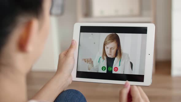 Woman is having a video conference with a doctor at home