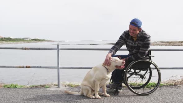 Man in a wheelchair enjoying free time with his dog
