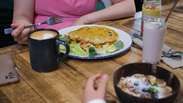 Closeup of Child with Mom Having Vegan Breakfast