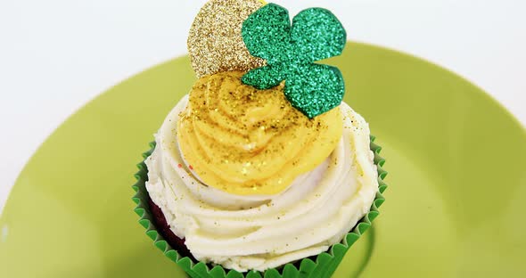 Muffin with white and yellow cream tooping for  st patricks