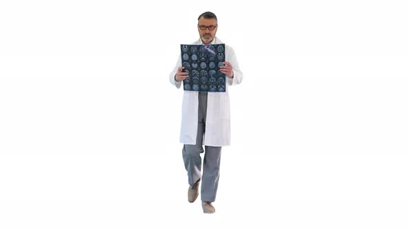 Mature Physician Walking and Reviewing a MRI Brain Scan on White Background