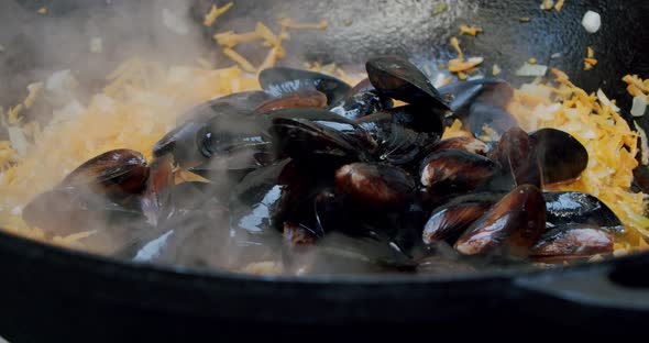 Close Up Chef Toassing Mussel Pan. Slow Motion V3