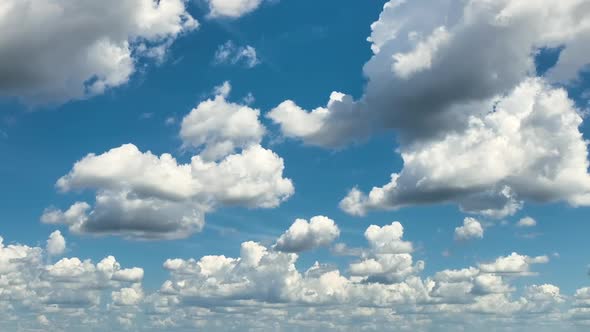 White Puffy Cumulus Clouds on Summer Blue Sky