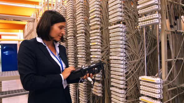 Female technician using digital cable analyzer