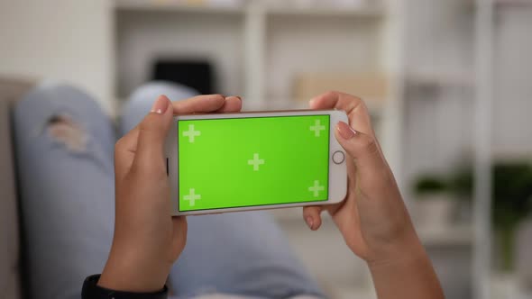 Closeup horizontal of hand woman using smartphone with green screen