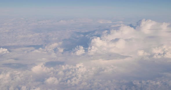 Beautiful Aerial View Of Clear Sky Over White Fluffy Clouds From Height Flight Of Plane