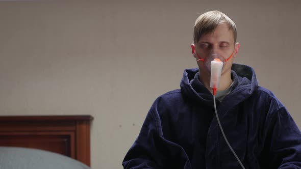 Man Sitting In Oxygen Mask