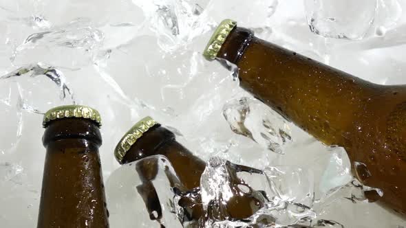 Guy Takes a Bottle of Cold Beer. White Background . Close Up. Slow Motion