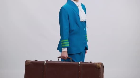Confident Girl in Stewardess Uniform Taking Retro Travel Bag Waving Smiling Leaving