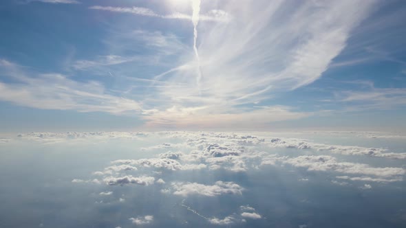 Aerial View From Airplane Window at High Altitude of Earth Covered with White Thin Layer of Misty