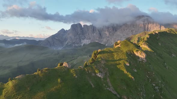 Dolomites mountains peaks with a hiking path on a summer sunrise