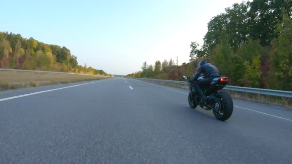 Follow To Biker Riding on Modern Sport Motorbike at Autumn Highway. Motorcyclist Racing His