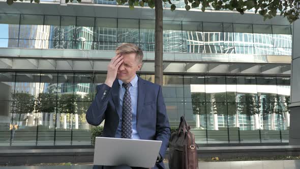Headache Tense Businessman Working on Laptop Sitting Outside