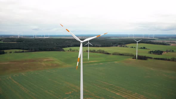 Drone Rising Above Large Windmill Turbine with Red Blade Stripes, Alternative Sustainable Eco Energy