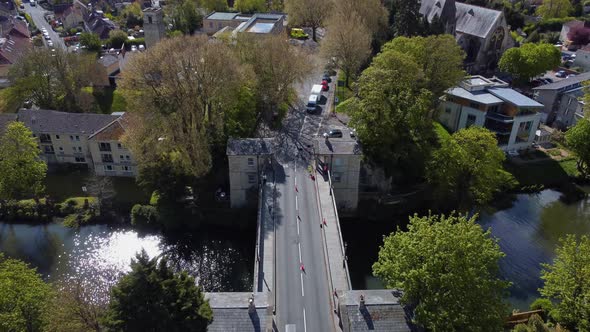 Aerial flying over a 19th century road toll bridge in the city of Bath, currently undergoing surveys