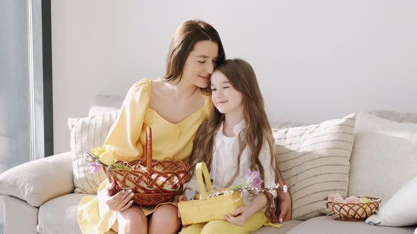 Pretty Young Mother in Yellow Dress Sitting with Kids on Coach on Easter