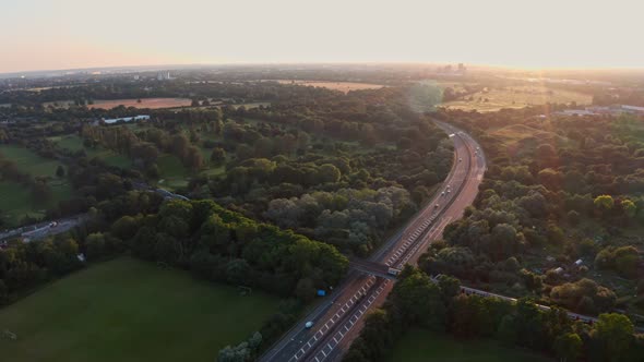 Follow drone shot of London Underground Piccadilly Line train at sunset