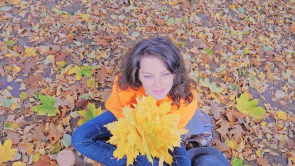 Happy Smiling Romantic Woman with Autumn Leaves