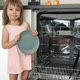 Girl Smiles Loads Dishes in Dishwasher - VideoHive Item for Sale
