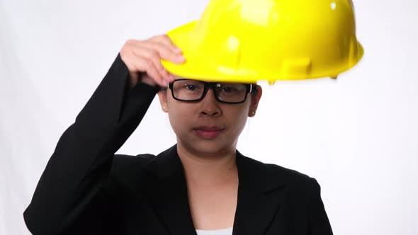 Woman technician smiling with helmet. Confident woman construction worker on white background.