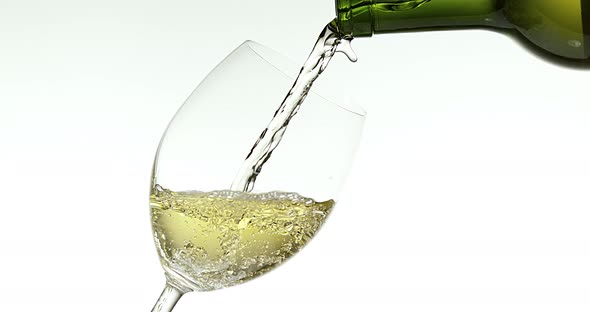 White Wine being poured into Glass, against White Background, Slow motion 4K