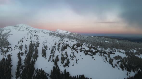 Aerial view of snowy mountain slope in Oregon, drone video of winter landscape