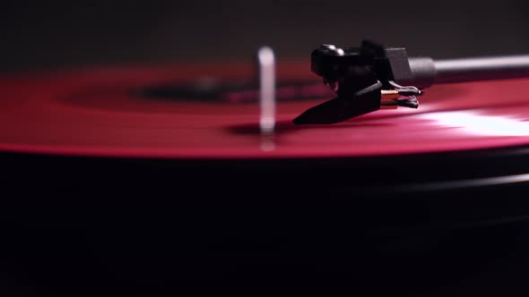 vinyl player. pink plate. Black background. motion