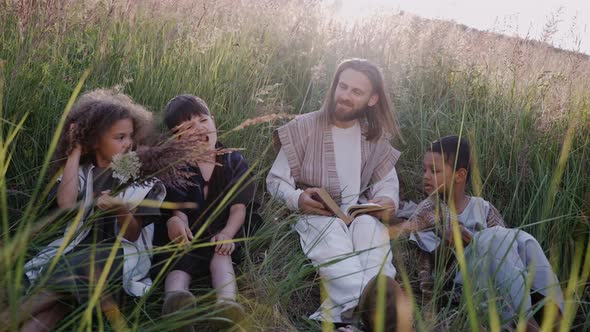 Jesus Sits on a Hill Among the Ears with Children and Reads a Book Scripture