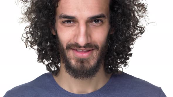 Closeup Portrait of Hairy Guy 27y with Curly Hair in Casual Dark Blue Tshirt Smiling While Being in