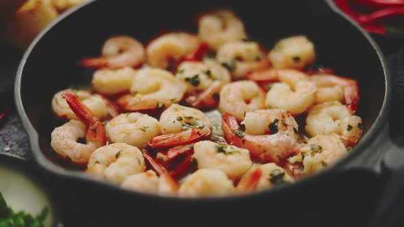 Fried Baby Shrimps Served on Iron Pan and Fresh Herbs and Ingredients. Top View, Flat Lay