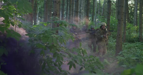 Equipped Soldiers Moving Through Smokey Forest