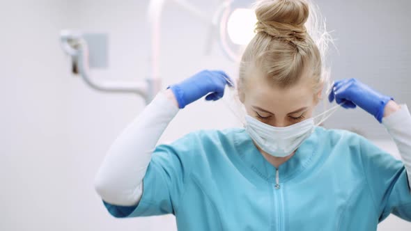 Medium Shot of Exhausted Dentist Sitting at Chair