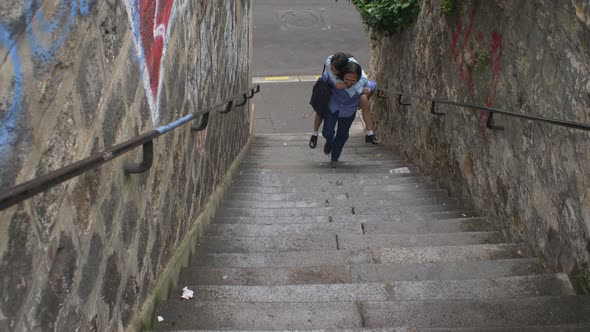 Couple walking on steps in Paris, France