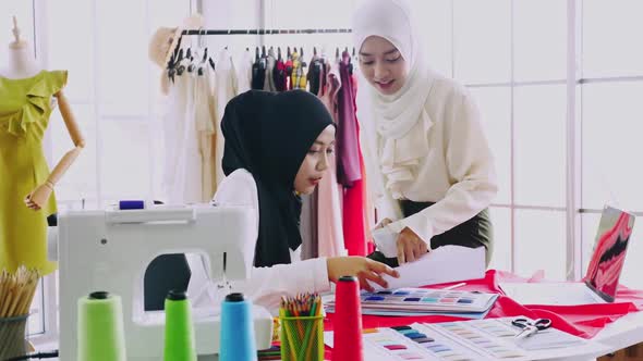 Muslim women fashion designers are in process of creating new clothes collection.