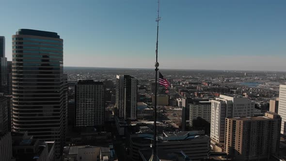 aerial footage American flag above buildings at downtown Minneapolis